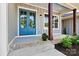 Inviting front porch featuring a stylish blue double door and wood columns at 252 Teeter Rd, Mooresville, NC 28115