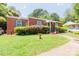 Charming brick home with a well-maintained lawn and blue shutters offers classic curb appeal at 3037 Marlowe Ave, Charlotte, NC 28208