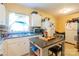 Bright kitchen with an island table, plenty of natural light and white cabinets at 3037 Marlowe Ave, Charlotte, NC 28208