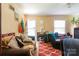 Cozy living room featuring a patterned red rug, sofa, and functional layout at 3037 Marlowe Ave, Charlotte, NC 28208