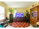Spacious living room featuring a large flat screen television and patterned red rug at 3037 Marlowe Ave, Charlotte, NC 28208