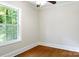 Bright bedroom featuring hardwood floors and a large window overlooking a leafy yard at 308 Davis Park Rd, Gastonia, NC 28052