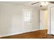 Hardwood floored bedroom with ceiling fan, closet and multiple doors at 308 Davis Park Rd, Gastonia, NC 28052