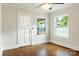 Sunny bedroom with hardwood flooring, and a door leading to the backyard at 308 Davis Park Rd, Gastonia, NC 28052
