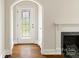 Inviting foyer with decorative glass front door, hardwood floors, and fireplace at 308 Davis Park Rd, Gastonia, NC 28052