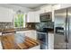 Modern kitchen features stainless steel appliances, wood countertops, and stylish backsplash at 308 Davis Park Rd, Gastonia, NC 28052