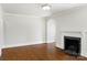 Neutral living room features hardwood floors, white trim and black fireplace at 308 Davis Park Rd, Gastonia, NC 28052