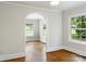 Bright and airy living room with hardwood floors and an arched doorway to another room at 308 Davis Park Rd, Gastonia, NC 28052