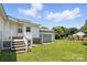 Exterior view of backyard, featuring lush lawn, wooden deck with stairs, and partial garage at 310 Sidney Johnson St, Fort Mill, SC 29715