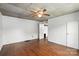 Bright bedroom featuring neutral walls, wood-look flooring, and standard closet at 310 Sidney Johnson St, Fort Mill, SC 29715