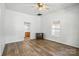 Bedroom featuring wood-look flooring, neutral walls, and a view to an adjacent bathroom at 310 Sidney Johnson St, Fort Mill, SC 29715