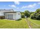 View of home from backyard showing a large lawn and attached garage at 310 Sidney Johnson St, Fort Mill, SC 29715