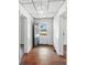 Inviting entryway with hardwood floors, white walls, and a view to the front door and outside at 310 Sidney Johnson St, Fort Mill, SC 29715