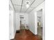 Bright hallway featuring wood-look floors, white wainscoting, and views into adjacent rooms at 310 Sidney Johnson St, Fort Mill, SC 29715