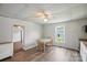 Eat-in kitchen features wood-look floors, white walls, and a charming ceiling fan at 310 Sidney Johnson St, Fort Mill, SC 29715