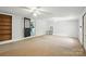 Spacious living room with ceiling fans, built-in shelves and an open doorway to the kitchen at 310 Sidney Johnson St, Fort Mill, SC 29715