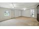 Bright living room features a window, two ceiling fans and doors to other rooms at 310 Sidney Johnson St, Fort Mill, SC 29715