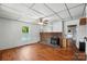 Cozy living room featuring a brick fireplace, hardwood floors, and a ceiling fan at 310 Sidney Johnson St, Fort Mill, SC 29715