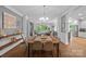 Elegant dining room with hardwood floors, chandelier, and view of the living area at 313 Sunset View Ct, York, SC 29745