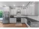 Well-lit kitchen featuring white cabinets, stainless steel appliances, and wooden floors at 313 Sunset View Ct, York, SC 29745