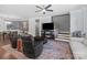 Cozy living room with stairs, large TV, stylish furniture, and hardwood floors at 313 Sunset View Ct, York, SC 29745