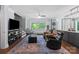 Spacious living room with hardwood floors, large windows, and comfortable seating area at 313 Sunset View Ct, York, SC 29745