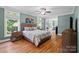 Bright main bedroom with hardwood floors, multiple windows, and a ceiling fan at 313 Sunset View Ct, York, SC 29745