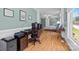 Bright office space featuring hardwood floors, blue walls, and a large window offering natural light at 313 Sunset View Ct, York, SC 29745
