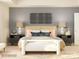 Inviting bedroom with a textured headboard, decorative pillows, side tables, lamps, and a cozy rug at 3823 Horsham St, Indian Land, SC 29707