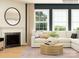 Inviting living room features a cozy fireplace, a neutral sectional, and large bright windows at 3823 Horsham St, Indian Land, SC 29707