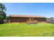 Spacious backyard with a wooden deck, lush green lawn, and mature trees offering a tranquil outdoor setting at 4128 River Run Cir, Hickory, NC 28602