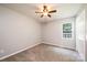 A carpeted bedroom with a ceiling fan and a window at 4128 River Run Cir, Hickory, NC 28602