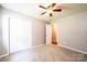 A cozy bedroom features neutral carpet, a ceiling fan and closet at 4128 River Run Cir, Hickory, NC 28602