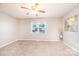 A carpeted bedroom with a ceiling fan and window at 4128 River Run Cir, Hickory, NC 28602