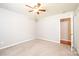 A cozy bedroom features neutral carpet and ceiling fan at 4128 River Run Cir, Hickory, NC 28602