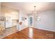 Open dining area features modern lighting, hardwood floors, and easy access to the kitchen at 4128 River Run Cir, Hickory, NC 28602