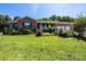 Attractive brick home with a cozy covered porch, lush landscaping, and well-kept front lawn at 4128 River Run Cir, Hickory, NC 28602