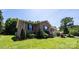 Beautiful brick home with a well-manicured lawn, mature landscaping, and a welcoming front porch at 4128 River Run Cir, Hickory, NC 28602