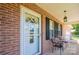 Inviting front porch with seating, brick facade, and decorative wreath on the front door at 4128 River Run Cir, Hickory, NC 28602