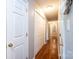 Hallway has hardwood floors, neutral walls, with access to various rooms at 4128 River Run Cir, Hickory, NC 28602