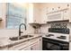 Well-lit kitchen showcasing granite countertops, modern backsplash, and stainless steel appliances at 4128 River Run Cir, Hickory, NC 28602