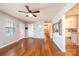 Open-concept living room with hardwood floors, neutral paint, and views into the kitchen at 4128 River Run Cir, Hickory, NC 28602