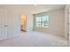 Cozy bedroom with neutral carpet, large window, and ensuite bathroom access at 4178 Skyboat Cir, Fort Mill, SC 29715