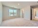 Large bedroom with neutral carpet, bright window, and connecting door to other rooms at 4178 Skyboat Cir, Fort Mill, SC 29715