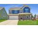 Charming two-story home featuring stone accents, a two-car garage, and a welcoming front porch at 4178 Skyboat Cir, Fort Mill, SC 29715