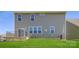 Two-story home featuring gray vinyl siding, a walkout patio, and a well-maintained lawn at 4178 Skyboat Cir, Fort Mill, SC 29715