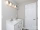 Bathroom with double sinks, white cabinets, silver hardware, and modern lighting fixture above vanity at 426 Williamson St, Rock Hill, SC 29730