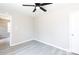 Spacious bedroom with light grey walls, wood-look floors, a modern ceiling fan, and white trim at 426 Williamson St, Rock Hill, SC 29730
