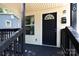Close-up of a charming front porch with freshly painted black trim and matching door at 426 Williamson St, Rock Hill, SC 29730