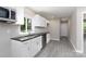 Modern kitchen featuring white cabinets, stainless steel appliances, and granite countertops at 426 Williamson St, Rock Hill, SC 29730